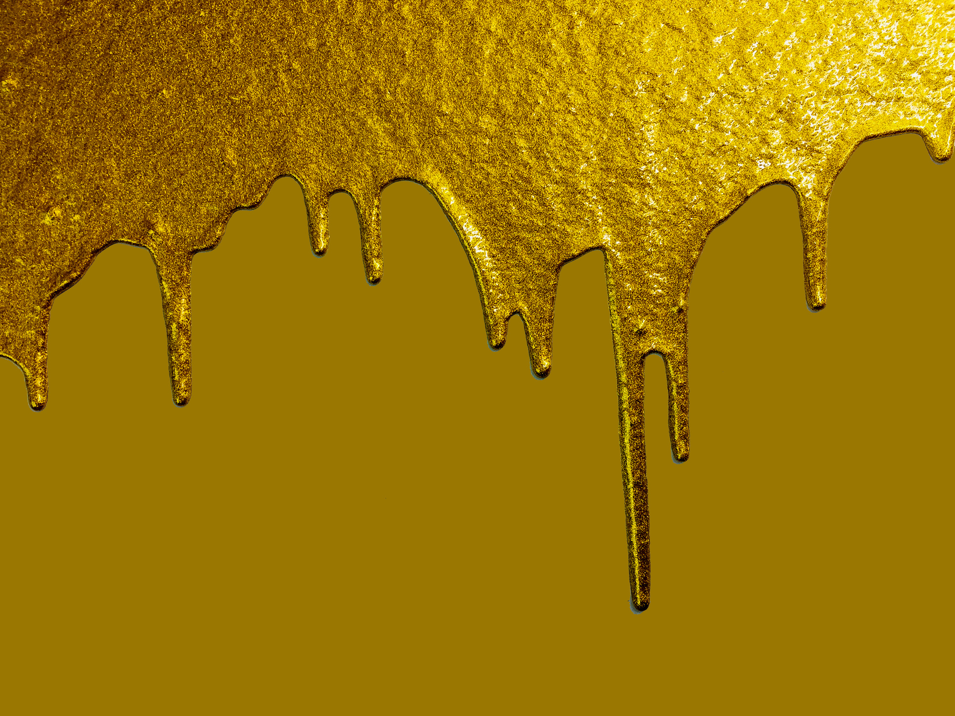Gold paint dripping on light gold background